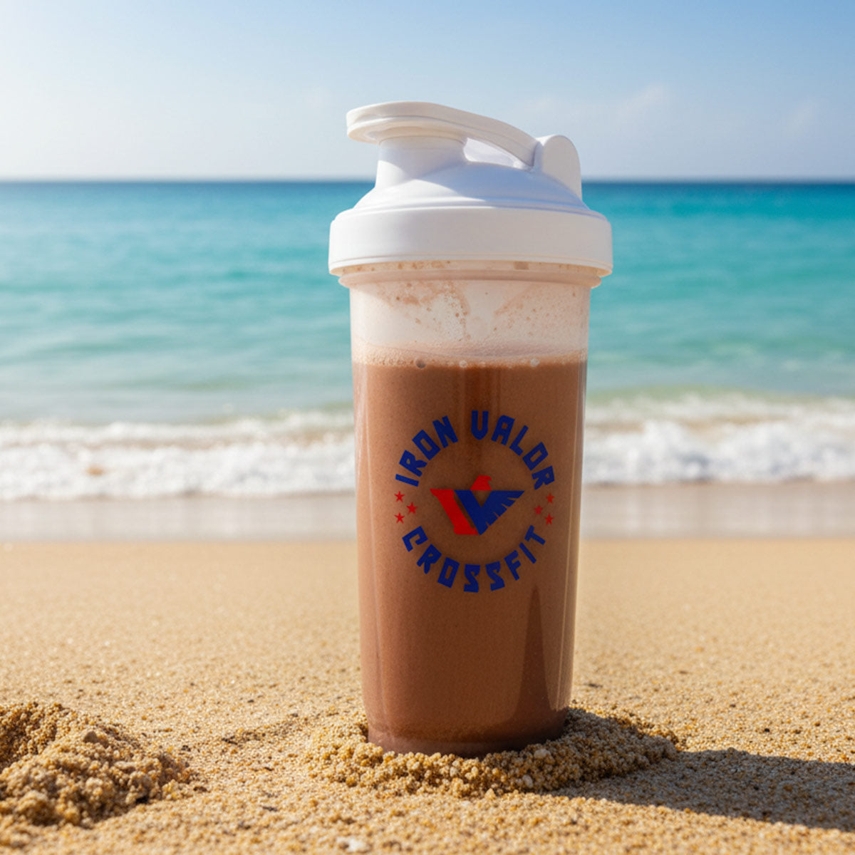 Shaker cup with 'Iron Valor CrossFit' logo on a beach With Chocolate Flavor