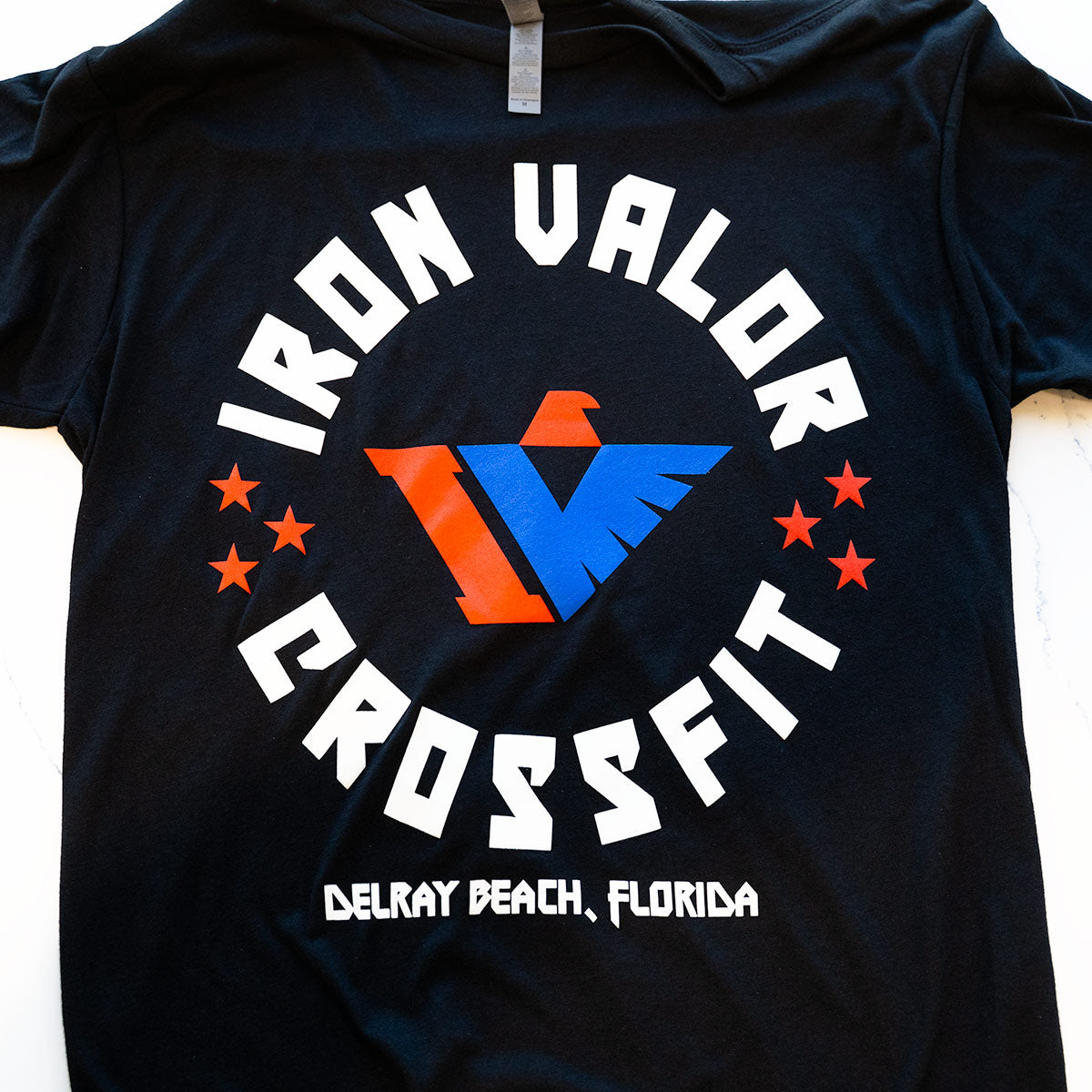 Black t-shirt with Iron Valor CrossFit logo and text on a white background