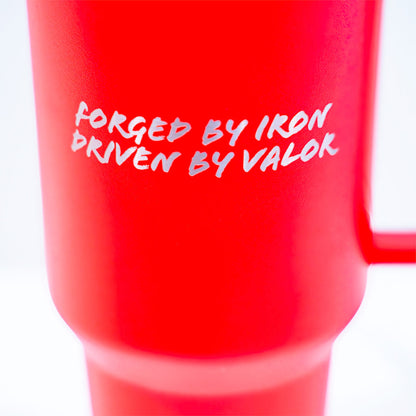 Red mug with white text 'FORGED BY IRON, DRIVEN BY VALOR' on a white background